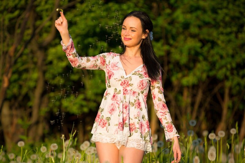 Woman in floral dress with dandelion