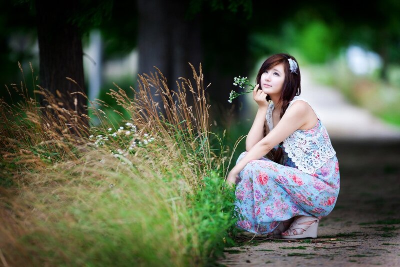 Woman in floral dress with flowers
