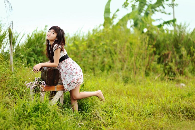 Woman in floral dress with suitcase