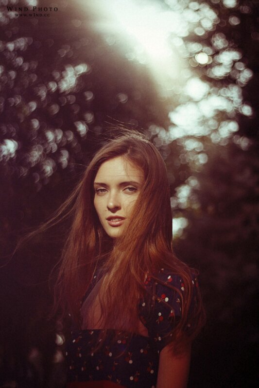 woman in floral dress with sunlit background