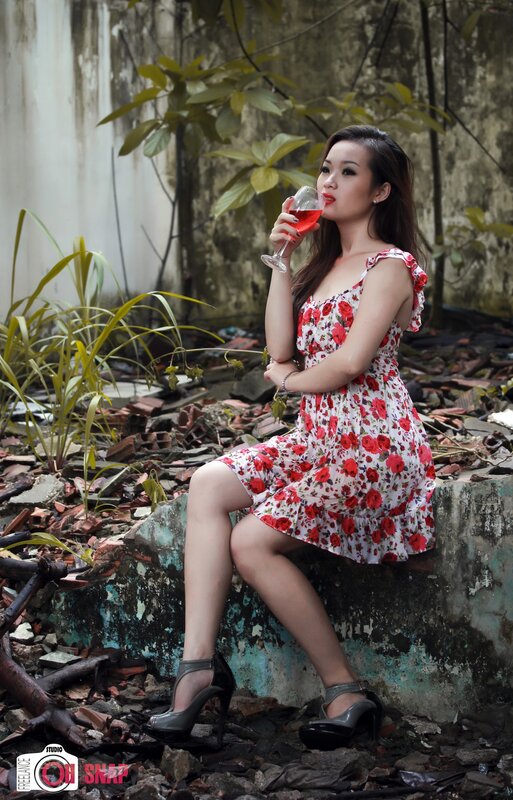 Woman in floral dress with wine