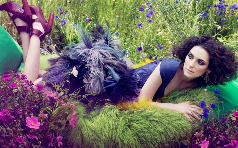 Woman in floral field with feathers