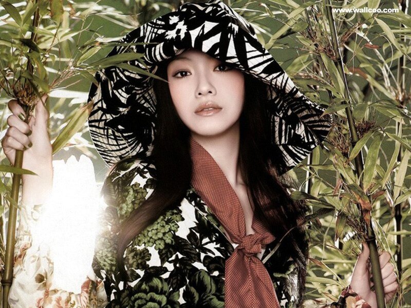 woman in floral hat among bamboo