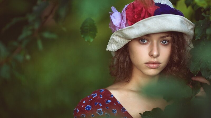 woman in floral hat outdoors