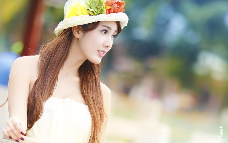 woman in floral hat outdoors
