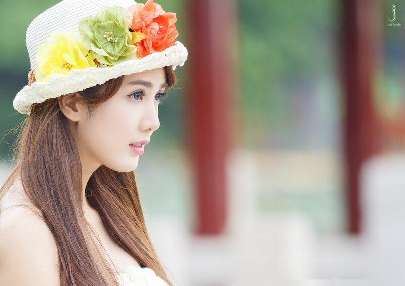 Woman in Floral Hat — White, Serene