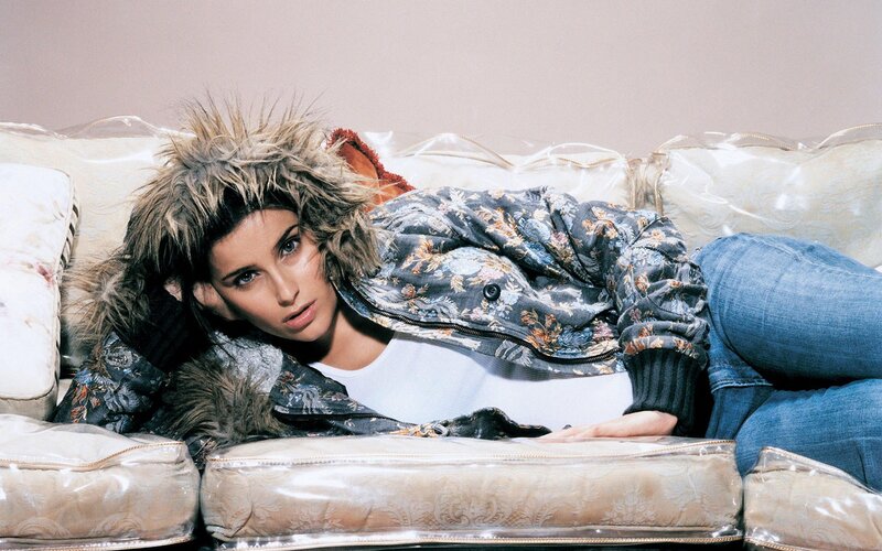 woman in floral jacket on couch
