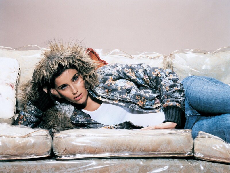 woman in floral jacket on couch