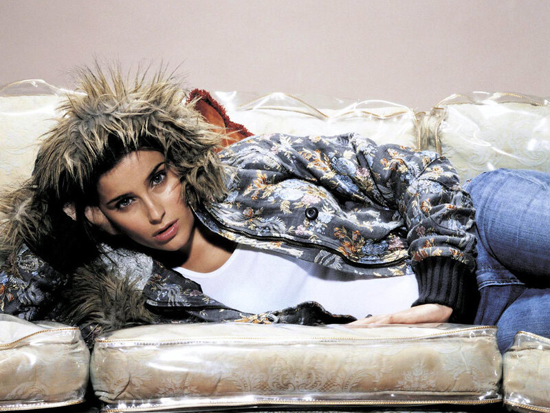 woman in floral jacket on couch