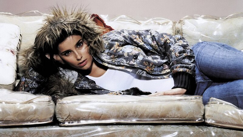 woman in floral jacket on couch