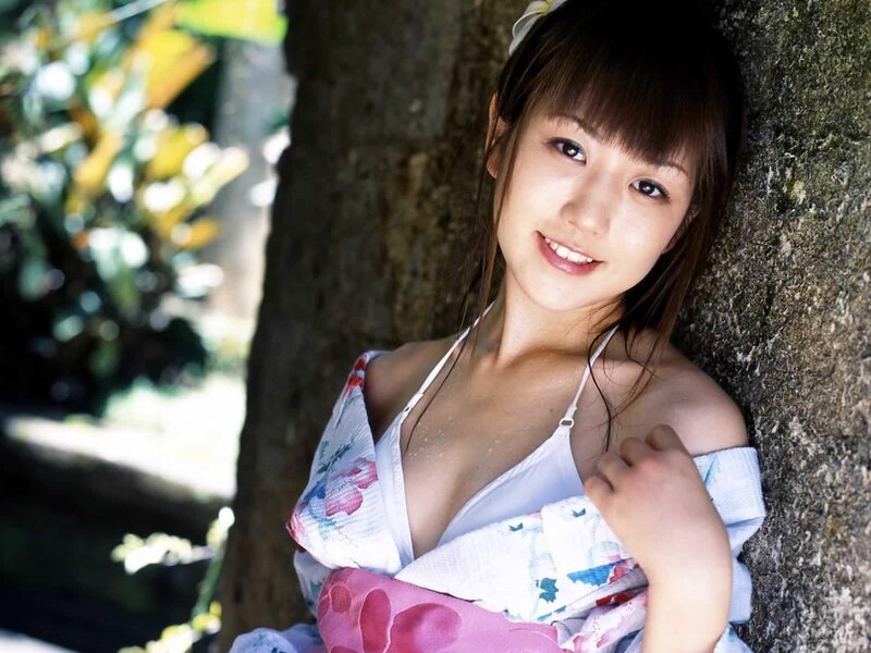 woman in floral kimono by tree