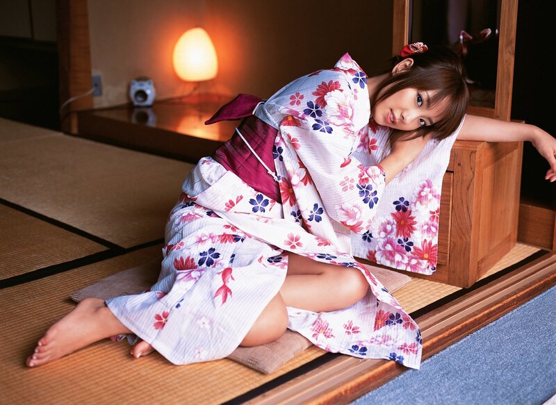 Woman in floral kimono on tatami