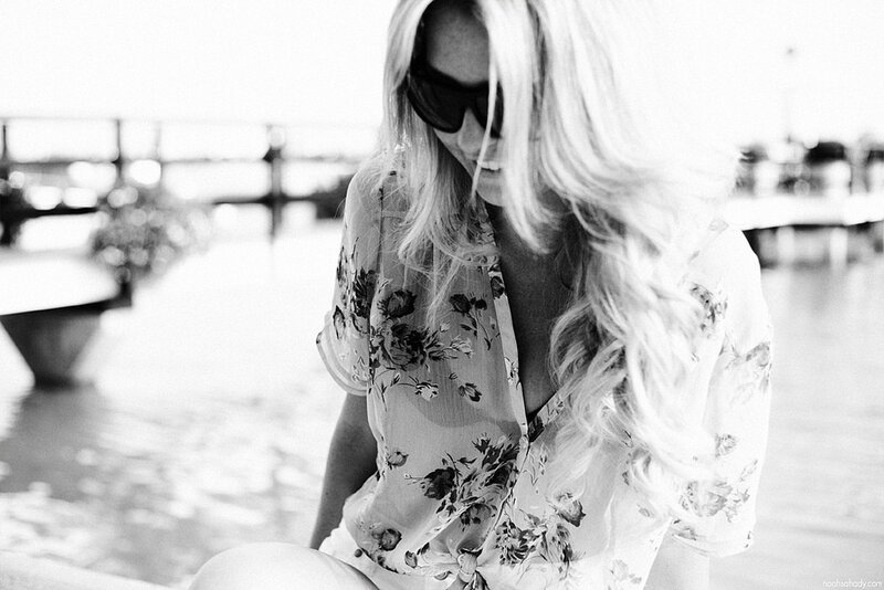 woman in floral shirt by water