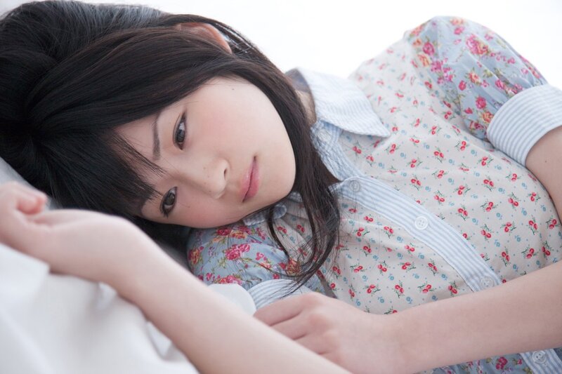 woman in floral shirt lying down