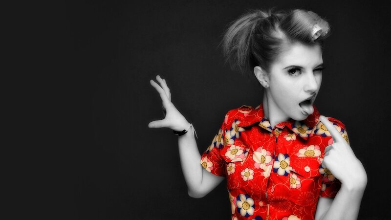 woman in floral shirt making face