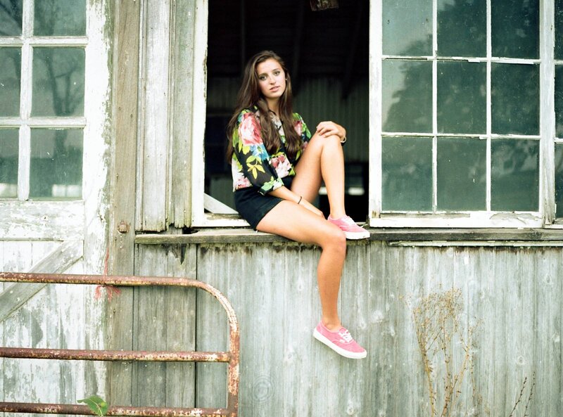 Woman in floral shirt on window sill