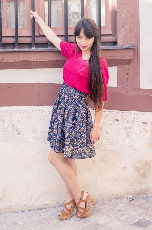 woman in floral skirt and pink top