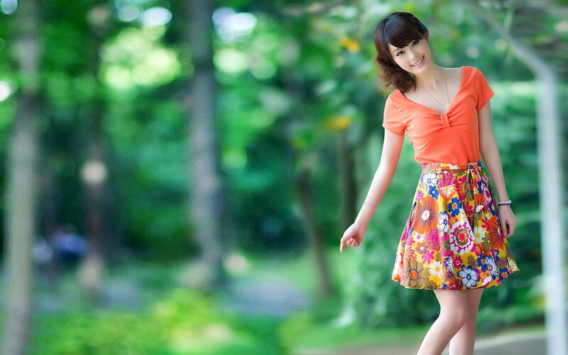 Woman in Floral Skirt — Orange, Serene