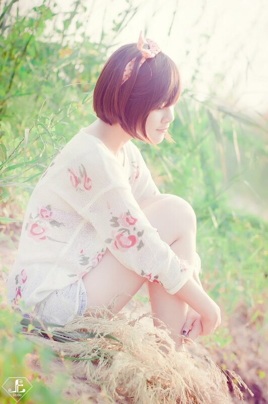 woman in floral sweater sitting