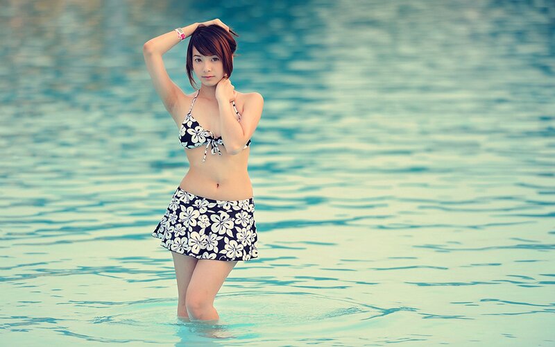 woman in floral swimsuit at pool