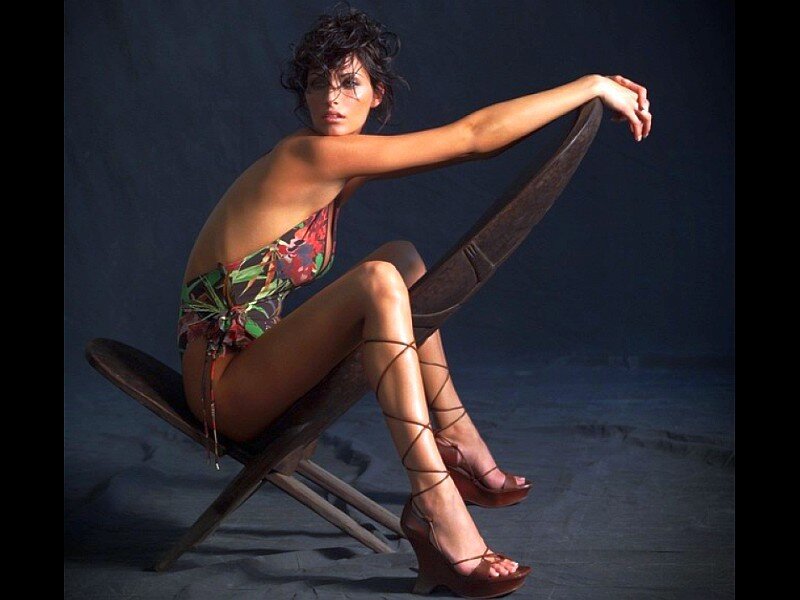 woman in floral swimsuit on chair