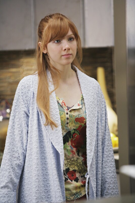 woman in floral top and cardigan