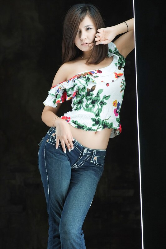 woman in floral top and jeans