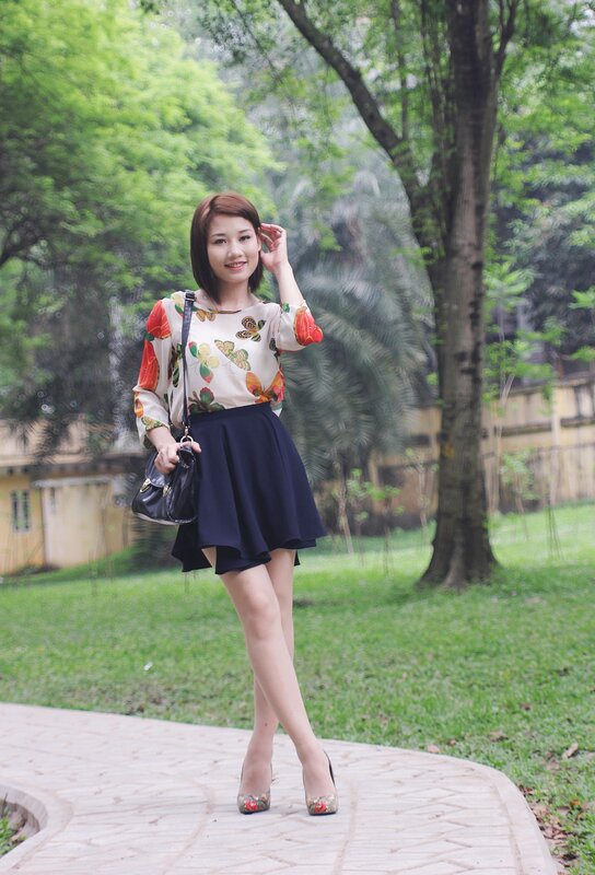 Woman in floral top and skirt