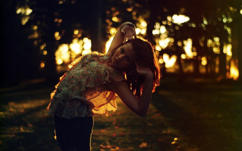 woman in floral top at sunset
