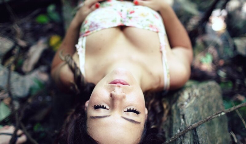 woman in floral top lying down