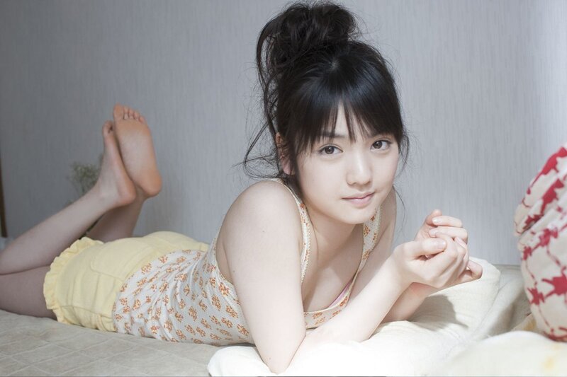 woman in floral top lying on bed