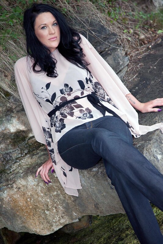 woman in floral top on rocks