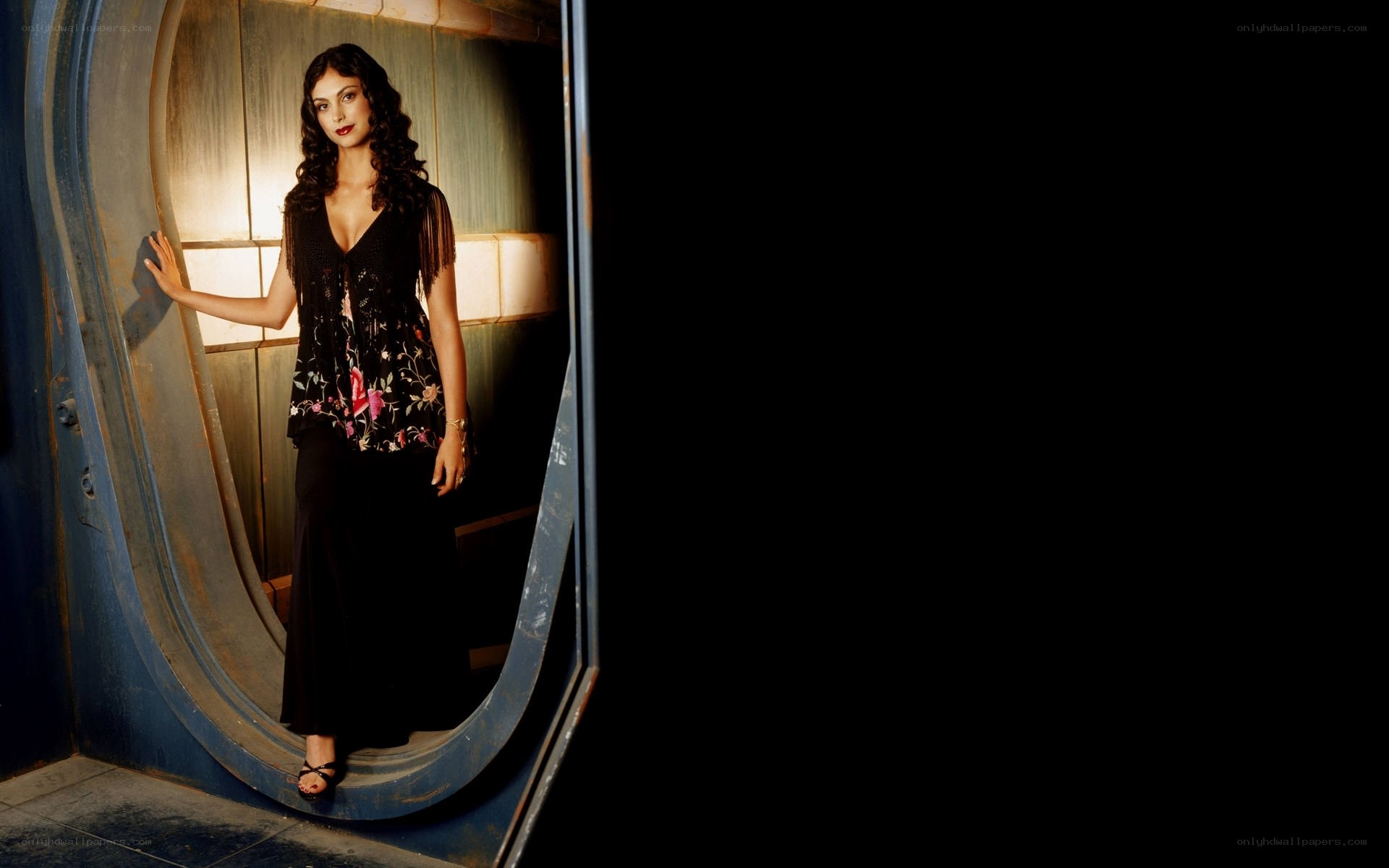 woman in floral top standing in doorway