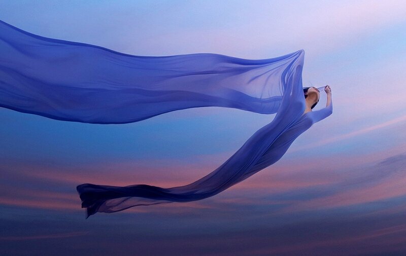 Woman in Flowing Blue Fabric
