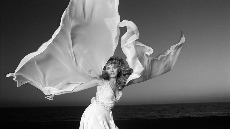 woman in flowing dress at beach