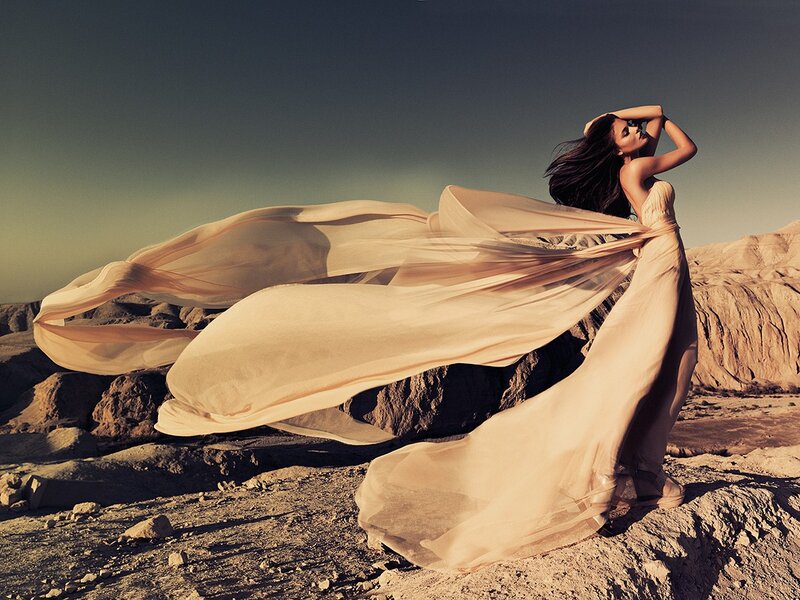 Woman in flowing dress in desert
