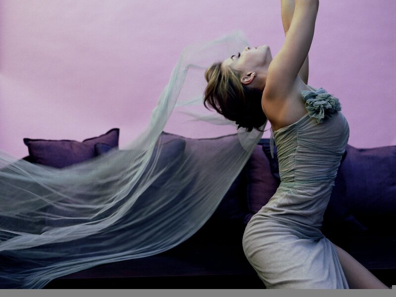 woman in flowing dress on couch