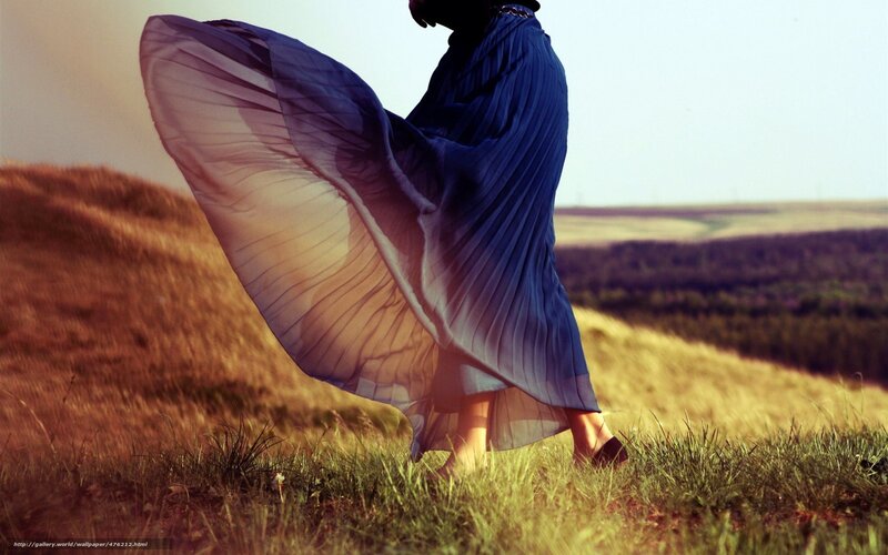 woman in flowing dress on hill