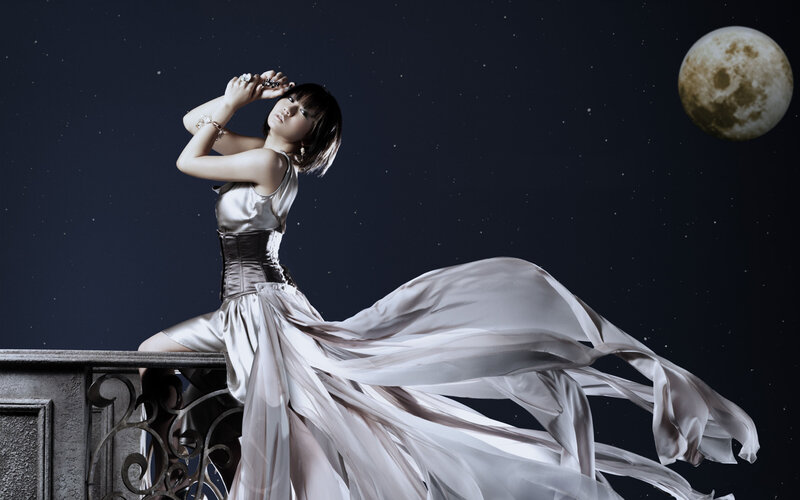 woman in flowing dress under moon