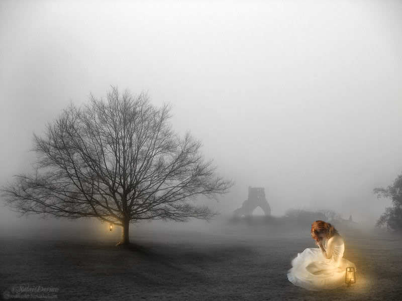 woman in fog with lantern