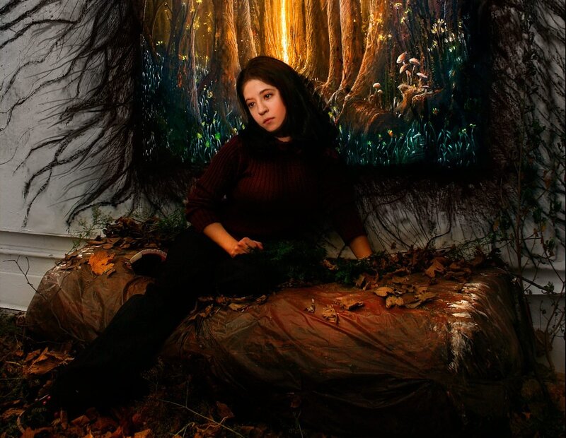 Woman in forest art installation
