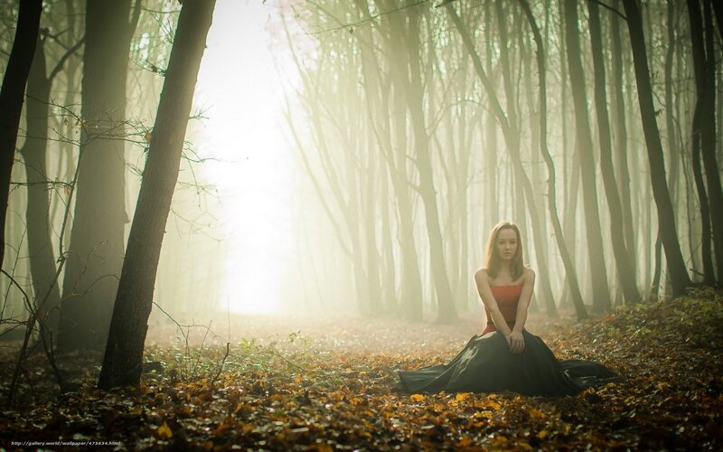 Woman in forest at dawn