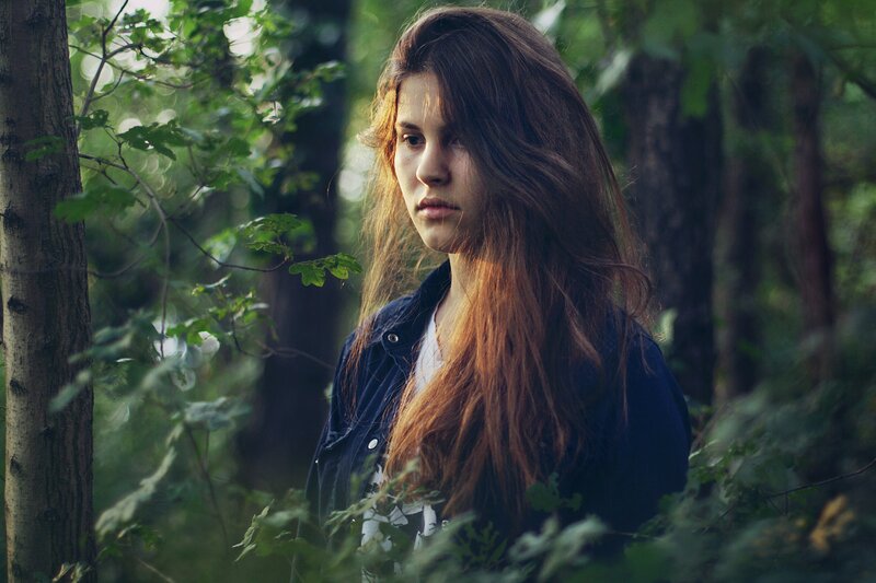 woman in forest at dusk