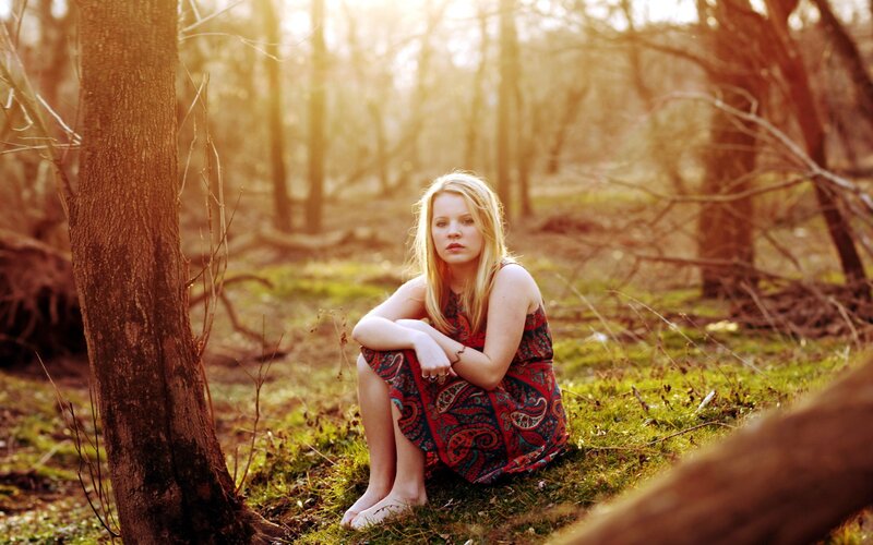 woman in forest at sunset