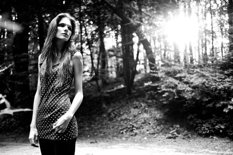 woman in forest at sunset