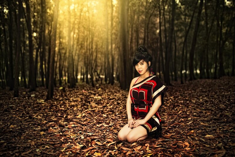 Woman in forest at sunset