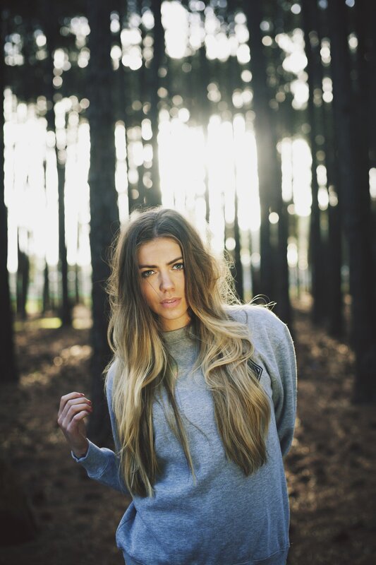 woman in forest at sunset