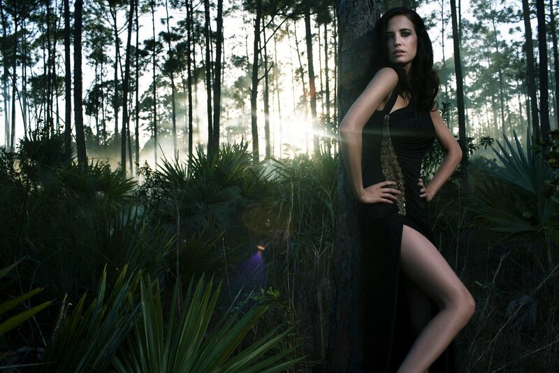 Woman in forest at sunset