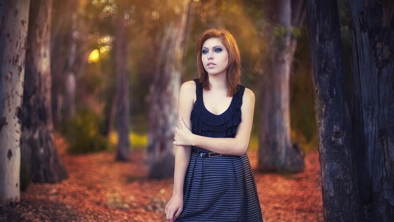woman in forest at sunset