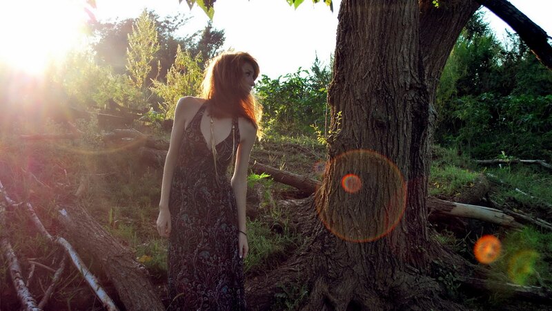 woman in forest at sunset